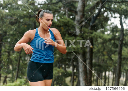 Unstoppable: A Determined Athlete Trains Through the Rain in Pursuit of Marathon Glory Unstoppable: A Determined Athlete Trains Through the Rain in Pursuit of Marathon Glory 127566496