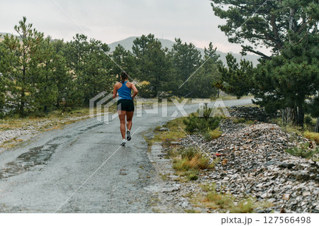 Unstoppable: A Determined Athlete Trains Through the Rain in Pursuit of Marathon Glory Unstoppable: A Determined Athlete Trains Through the Rain in Pursuit of Marathon Glory 127566498