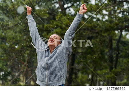 Beautiful Woman Enjoying Rainy Day After Intense Run 127566562