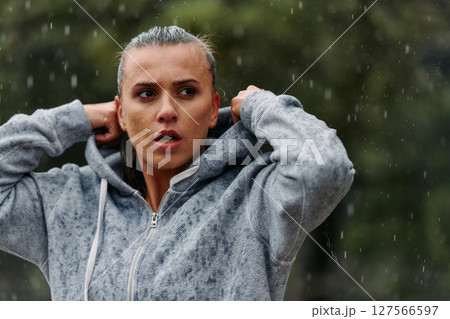 Woman Resting in the Rain After Intense Run Woman Resting in the Rain After Intense Run 127566597