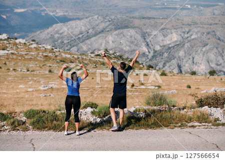 Joyful Couple Celebrating the Successful Completion of a Morning Run. Joyful Couple Celebrating the Successful Completion of a Morning Run. 127566654
