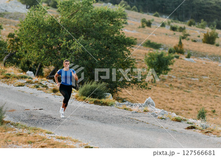 Empowered Runner Embracing Nature's Beauty on a Serene Morning Trail. Empowered Runner Embracing Nature's Beauty on a Serene Morning Trail. 127566681