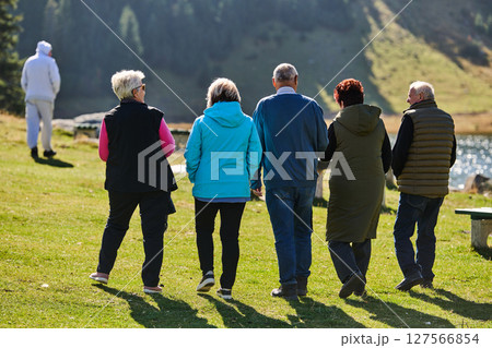 A family shares delightful moments with their friends amid the stunning landscapes of mountains, lakes, and winding paths, promoting a healthy lifestyle and the joy of familial bonds in the embrace of A family shares delightful moments with their friends amid the stunning landscapes of mountains, lakes, and winding paths, promoting a healthy lifestyle and the joy of familial bonds in the embrace of 127566854