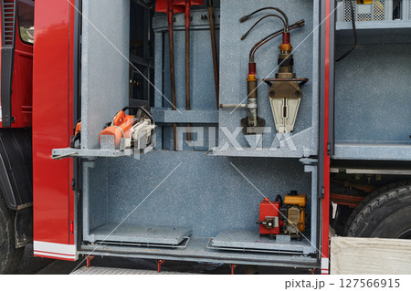 Close-up of essential firefighting equipment on a modern firetruck, showcasing tools and gear ready for emergency response to hazardous fire situations 127566915