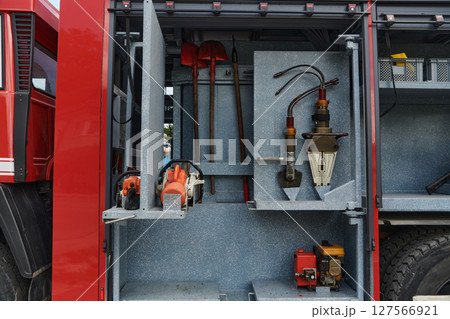 Close-up of essential firefighting equipment on a modern firetruck, showcasing tools and gear ready for emergency response to hazardous fire situations Close-up of essential firefighting equipment on a modern firetruck, showcasing tools and gear ready for emergency response to hazardous fire situations 127566921