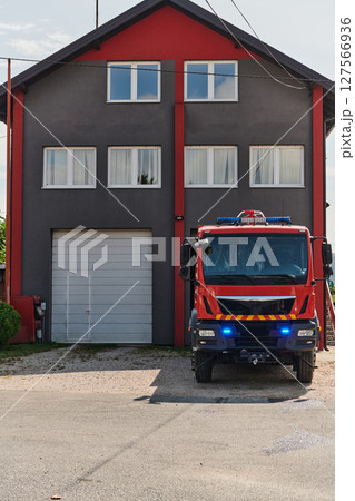 A state-of-the-art firetruck, equipped with advanced rescue technology, stands ready with its skilled firefighting team, prepared to intervene and respond rapidly to emergencies, ensuring the safety 127566936