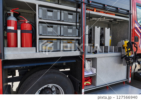 Close-up of essential firefighting equipment on a modern firetruck, showcasing tools and gear ready for emergency response to hazardous fire situations Close-up of essential firefighting equipment on a modern firetruck, showcasing tools and gear ready for emergency response to hazardous fire situations 127566940