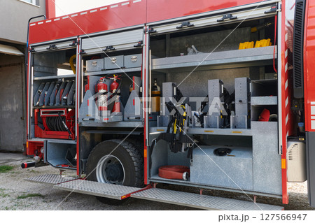 Close-up of essential firefighting equipment on a modern firetruck, showcasing tools and gear ready for emergency response to hazardous fire situations Close-up of essential firefighting equipment on a modern firetruck, showcasing tools and gear ready for emergency response to hazardous fire situations 127566947