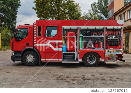 A state-of-the-art firetruck, equipped with advanced rescue technology, stands ready with its skilled firefighting team, prepared to intervene and respond rapidly to emergencies, ensuring the safety A state-of-the-art firetruck, equipped with advanced rescue technology, stands ready with its skilled firefighting team, prepared to intervene and respond rapidly to emergencies, ensuring the safety 127567015