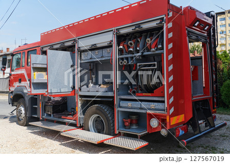 Close-up of essential firefighting equipment on a modern firetruck, showcasing tools and gear ready for emergency response to hazardous fire situations Close-up of essential firefighting equipment on a modern firetruck, showcasing tools and gear ready for emergency response to hazardous fire situations 127567019