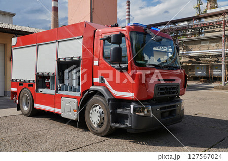 A state-of-the-art firetruck, equipped with advanced rescue technology, stands ready with its skilled firefighting team, prepared to intervene and respond rapidly to emergencies, ensuring the safety A state-of-the-art firetruck, equipped with advanced rescue technology, stands ready with its skilled firefighting team, prepared to intervene and respond rapidly to emergencies, ensuring the safety 127567024
