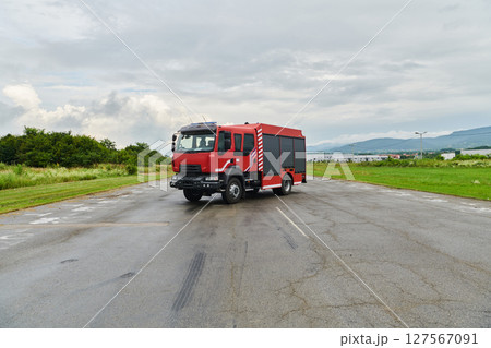 In this captivating scene, a state-of-the-art firetruck, equipped with advanced rescue technology, stands ready with its skilled firefighting team, prepared to intervene and respond rapidly to In this captivating scene, a state-of-the-art firetruck, equipped with advanced rescue technology, stands ready with its skilled firefighting team, prepared to intervene and respond rapidly to 127567091