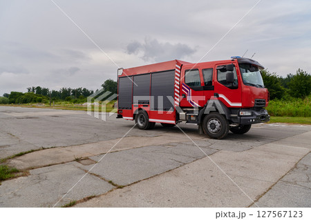 In this captivating scene, a state-of-the-art firetruck, equipped with advanced rescue technology, stands ready with its skilled firefighting team, prepared to intervene and respond rapidly to In this captivating scene, a state-of-the-art firetruck, equipped with advanced rescue technology, stands ready with its skilled firefighting team, prepared to intervene and respond rapidly to 127567123