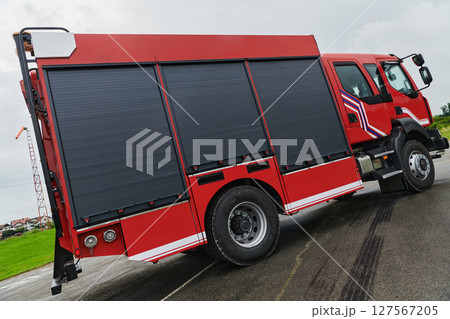In this captivating scene, a state-of-the-art firetruck, equipped with advanced rescue technology, stands ready with its skilled firefighting team, prepared to intervene and respond rapidly to In this captivating scene, a state-of-the-art firetruck, equipped with advanced rescue technology, stands ready with its skilled firefighting team, prepared to intervene and respond rapidly to 127567205