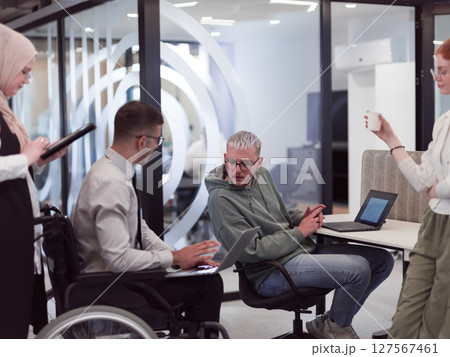 Young group of business people brainstorming together in a startup space, discussing business projects, investments, and solving challenges. 127567461