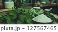 Display of fresh mint leaves alongside natural ingredients for toothpaste production. 127567465
