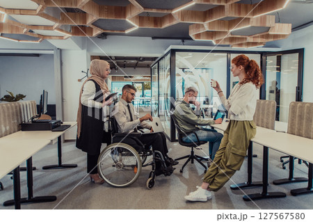 Young group of business people brainstorming together in a startup space, discussing business projects, investments, and solving challenges. 127567580