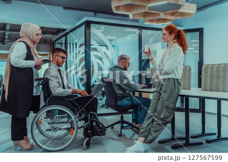 Young group of business people brainstorming together in a startup space, discussing business projects, investments, and solving challenges. Young group of business people brainstorming together in a startup space, discussing business projects, investments, and solving challenges. 127567599