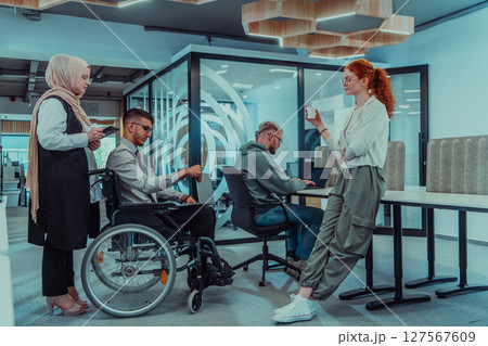 Young group of business people brainstorming together in a startup space, discussing business projects, investments, and solving challenges. Young group of business people brainstorming together in a startup space, discussing business projects, investments, and solving challenges. 127567609