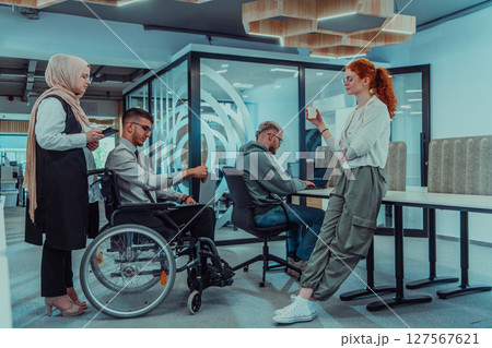 Young group of business people brainstorming together in a startup space, discussing business projects, investments, and solving challenges. Young group of business people brainstorming together in a startup space, discussing business projects, investments, and solving challenges. 127567621