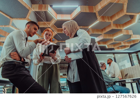 Young group of business people brainstorming together in a startup space, discussing business projects, investments, and solving challenges. Young group of business people brainstorming together in a startup space, discussing business projects, investments, and solving challenges. 127567626