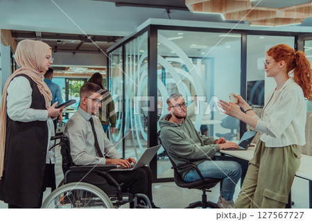 Young group of business people brainstorming together in a startup space, discussing business projects, investments, and solving challenges. Young group of business people brainstorming together in a startup space, discussing business projects, investments, and solving challenges. 127567727