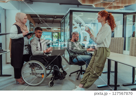 Young group of business people brainstorming together in a startup space, discussing business projects, investments, and solving challenges. Young group of business people brainstorming together in a startup space, discussing business projects, investments, and solving challenges. 127567870