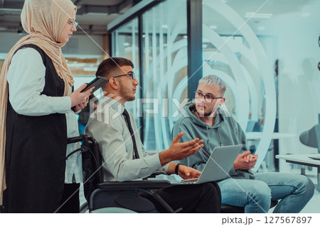 Young group of business people brainstorming together in a startup space, discussing business projects, investments, and solving challenges. Young group of business people brainstorming together in a startup space, discussing business projects, investments, and solving challenges. 127567897