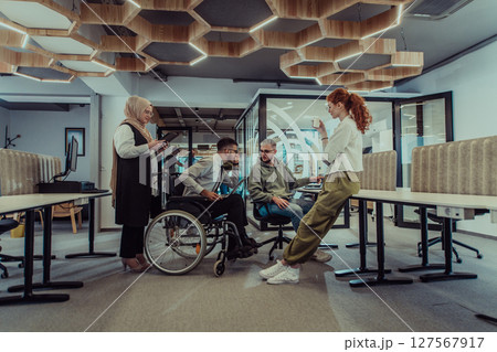 Young group of business people brainstorming together in a startup space, discussing business projects, investments, and solving challenges. 127567917