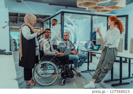 Young group of business people brainstorming together in a startup space, discussing business projects, investments, and solving challenges. Young group of business people brainstorming together in a startup space, discussing business projects, investments, and solving challenges. 127568023