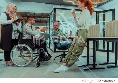Young group of business people brainstorming together in a startup space, discussing business projects, investments, and solving challenges. 127568057