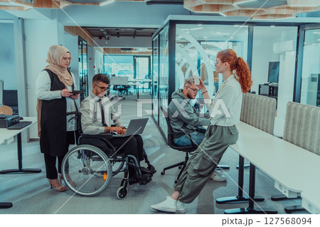 Young group of business people brainstorming together in a startup space, discussing business projects, investments, and solving challenges. 127568094