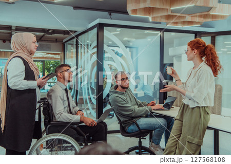 Young group of business people brainstorming together in a startup space, discussing business projects, investments, and solving challenges. Young group of business people brainstorming together in a startup space, discussing business projects, investments, and solving challenges. 127568108