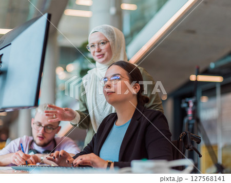 In a modern startup office, a diverse group of young professionals collaboratively tackles various business problems and challenges, surrounded by their engaged colleagues, fostering innovation and 127568141