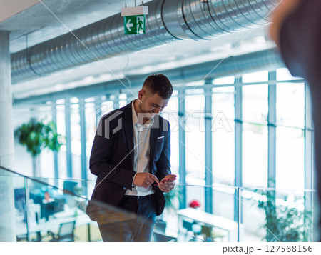 In a sleek corporate setting, the young and charismatic director strides confidently down the hallway, symbolizing his dynamic leadership and the promise of continued success within the company he In a sleek corporate setting, the young and charismatic director strides confidently down the hallway, symbolizing his dynamic leadership and the promise of continued success within the company he 127568156