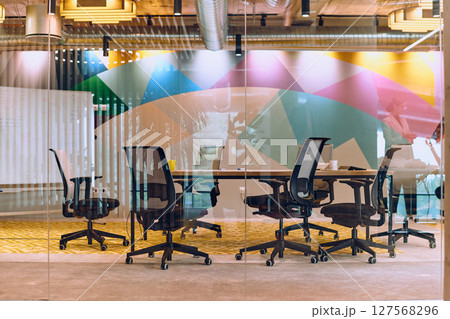 In the contemporary setting of an empty modern glass startup office, the space exudes a sleek and innovative atmosphere, ready to be filled with the potential of entrepreneurial endeavors 127568296
