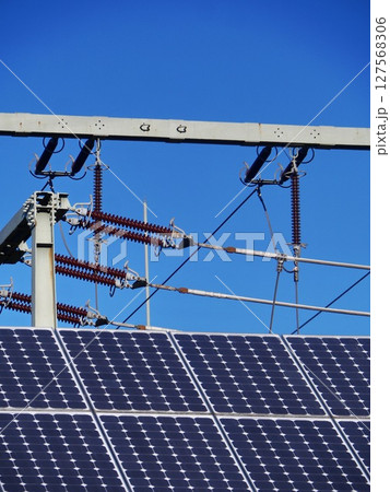 A solar panel is on top of a power line A solar panel is on top of a power line 127568306