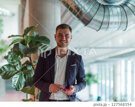 In a sleek corporate setting, the young and charismatic director strides confidently down the hallway, symbolizing his dynamic leadership and the promise of continued success within the company he In a sleek corporate setting, the young and charismatic director strides confidently down the hallway, symbolizing his dynamic leadership and the promise of continued success within the company he 127568354