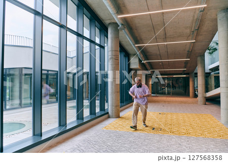 Amidst an atmosphere of exuberance, a joyful, blonde man energetically departs for a business meeting, radiating positivity, enthusiasm, and a vibrant spirit in the contemporary corporate world 127568358