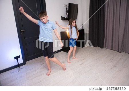 Dancing duo showcases infectious energy in a stylish living room during a joyful afternoon, highlighting creativity and liveliness Dancing duo showcases infectious energy in a stylish living room during a joyful afternoon, highlighting creativity and liveliness 127568530