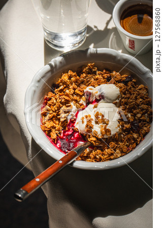 Portion of gourmet granola and yogurt bowl Portion of gourmet granola and yogurt bowl 127568860