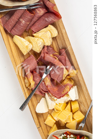 Portion of antipasti platter with cheese and meat 127568863