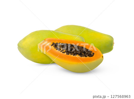 Green papaya fruits and a cut in half isolated. Green papaya fruits and a cut in half isolated. 127568963