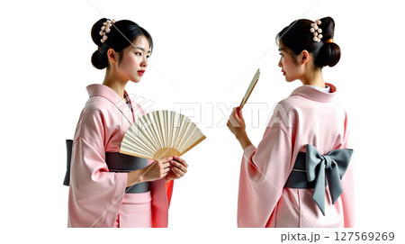 A young Japanese woman wears a modern kimono while posing in two different stances. She holds a fan, exuding grace and elegance, perfectly embodying traditional and contemporary style. 127569269