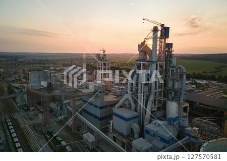 Cement plant with high factory structure and tower cranes at industrial production area. Manufacture and global industry concept 127570581
