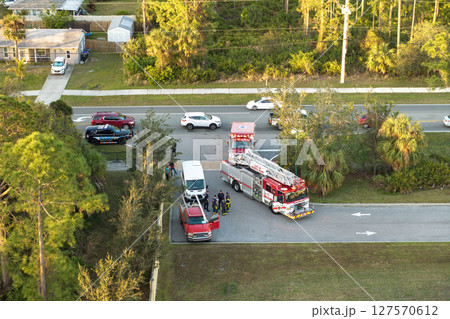 Car crash with first responders helping at accident site on American street. Vehicle collision on road in USA 127570612