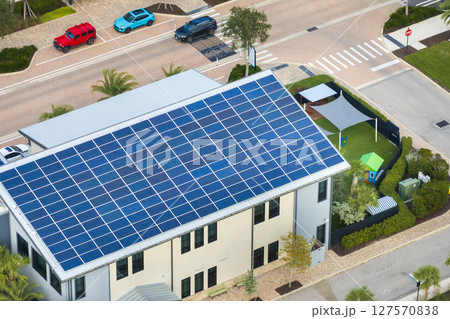 Autonomous building in Florida with photovoltaic rooftop covered with solar panels for producing of clean ecological electrical energy in town center 127570838