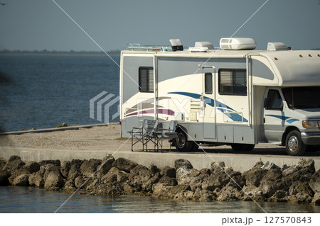 American motorhome parked on ocean shore in Florida. USA travel destination infrastructure. American motorhome parked on ocean shore in Florida. USA travel destination infrastructure. 127570843