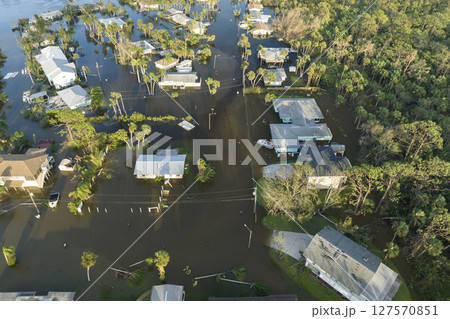 Aftermath of natural disaster. Surrounded by hurricane rainfall flood waters homes in Florida residential area 127570851