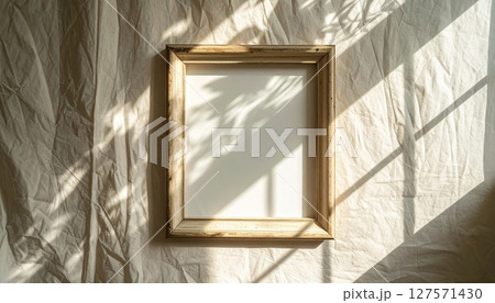 Empty Beige Wooden Frame with Sunlight and Shadows Empty Beige Wooden Frame with Sunlight and Shadows 127571430